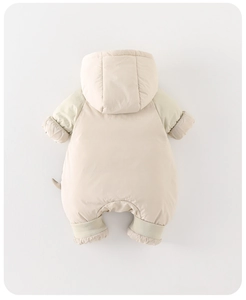 Detail view of baby snowsuit featuring ribbed windproof cuffs and soft plush tail decoration