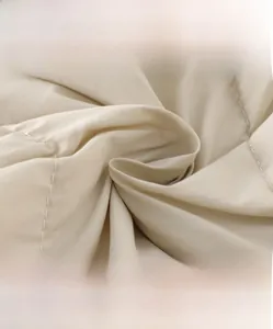 Detail view of high-density soft fabric showing quilting texture and breathable material