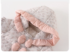 Detailed view of floral baby puffer jumpsuit with pink ruffles and quilted texture