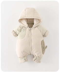 Detail of baby winter down romper showing quilted fabric, zipper, and cute puppy pocket