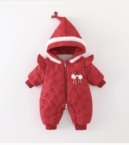 Close-up of red infant romper featuring quilted floral texture and plush faux fur hood trim