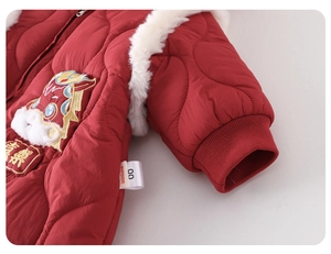 Detail of red quilted baby winter romper featuring cute dragon embroidery and fur trim