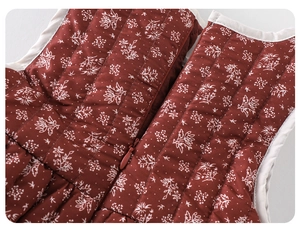 Detail of baby winter floral quilted dress featuring secure zipper and fine piping edge