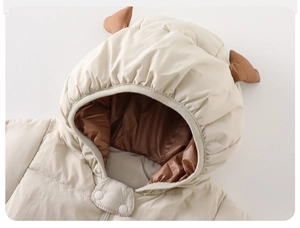 Close-up of baby winter romper hood with cute decorative horns and white snap buttons