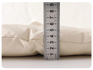 Close-up showing the 40mm thick white duck down padding of this baby winter jumpsuit