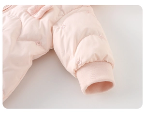 Detailed close-up of baby winter romper sleeve featuring floral embroidery and ribbed cuffs