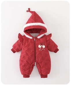 Detail of red quilted baby romper featuring faux fur trim hood and elegant bow accent