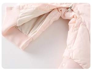 Detailed close-up of baby romper showing floral embroidery and rib knit cuffs