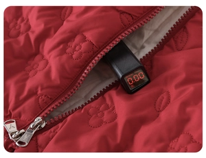 Detail of red quilted baby suit showing flower patterns and fluorescence safety test