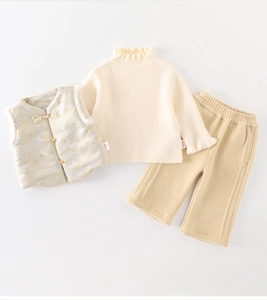 Detailed view of baby girl three-piece set with quilted vest and knit sweater