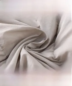 Detail of high-density knitted grey fabric texture showing soft breathable weave
