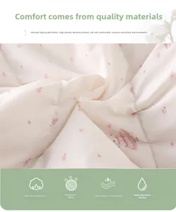 Close-up of soft white fabric with pink floral and rabbit prints for baby romper
