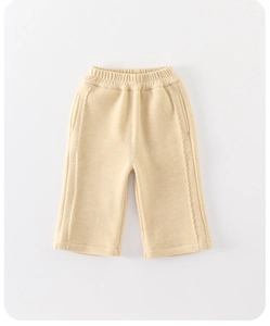 Detail of baby warm trousers in apricot with elastic waist and wavy side stitching