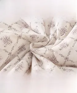 Detail of floral infant romper fabric showing soft texture and breathable weave
