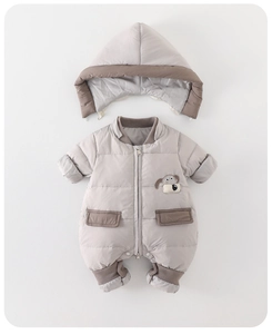 Detail of baby winter jumpsuit featuring 90% white duck down and cute dog embroidery