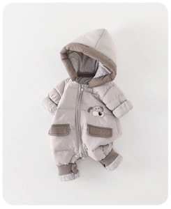Detail of baby quilted down romper showing windproof elastic cuffs and zipper closure