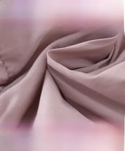 Detailed close-up of high-density pink textile fabric showing soft and breathable texture