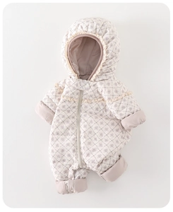 Detailed close-up of baby winter romper with purple floral patterns and lace trim