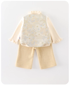 Detail of baby winter outfit featuring jacquard vest and ruffled mock neck knit shirt