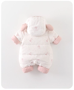 Close-up of baby winter jumpsuit with pink rabbit print and 3D ears on a cream fabric