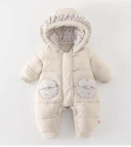 Detailed macro view of baby down romper with floral ruffles and a warm quilted texture
