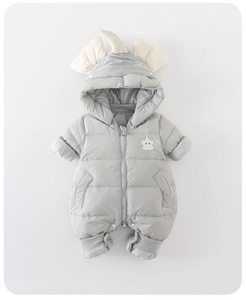 Detail of baby winter jumpsuit featuring a hooded unicorn design and windproof ribbed cuffs