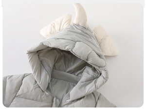 Detail showing hooded baby romper with unicorn horn and quilted windproof fabric
