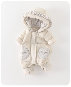 Detail of baby quilted romper with ruffled hood and purple floral fabric lining