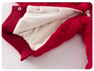 Detail of red plush baby romper with warm white fleece lining and metal zipper closure