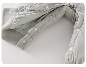 Detail of baby down jumpsuit featuring secure metal zipper and reinforced snap buttons