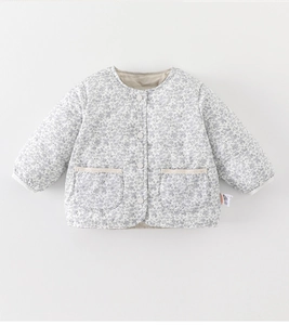 Detail of baby girl floral quilted jacket with beige fabric and purple flower patterns