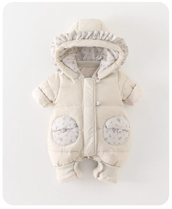 Close-up of baby puffer jumpsuit with floral lining, ruffled hood and quilted texture