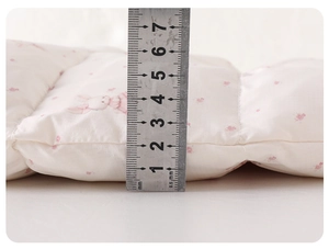 Detailed side view showing the 3cm thickness of the quilted floral baby winter jumpsuit