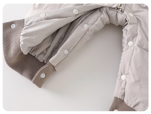 Detail of snap button crotch and ribbed cuffs on quilted baby winter romper