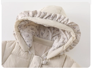 Detail of baby down romper with floral lining and ruffled hood edge in cream white
