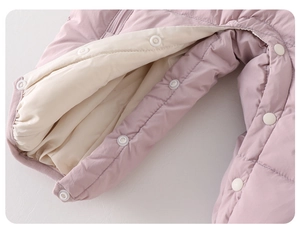 Detail view of baby quilted winter romper featuring secure resin snaps and smooth zipper