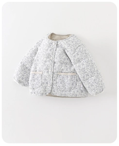 Close-up of baby girl floral quilted jacket with snap buttons and square texture