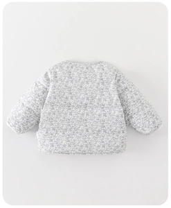 Detailed close-up of light blue floral quilted cotton fabric on baby winter jacket
