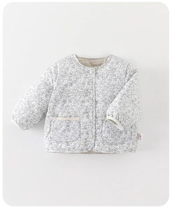 Detail of floral quilted baby girl jacket with lace pockets and white buttons