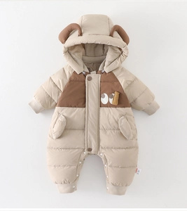 Detail of baby winter romper with cute ear hood, thick quilted fabric and ribbed cuffs