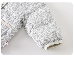 Detail of baby girl floral puffer jacket with lace trim and elastic windproof cuffs