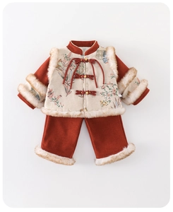 Detail of baby girl traditional red corduroy Tang suit with fur trim and floral brocade