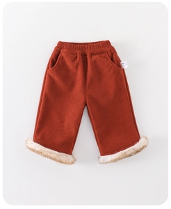 Detailed view of brick red corduroy baby pants with plush fur trim and elastic waist