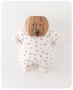 Detail view of winter baby romper with autumn leaf patterns and cute nut hood design