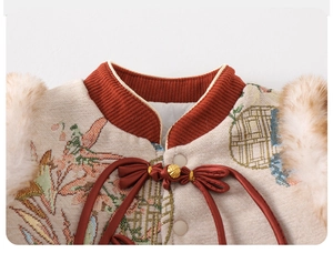 Close-up of traditional embroidery collar with faux fur trim and red butterfly bow