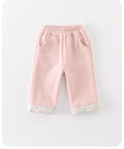 Close-up of pink toddler pants featuring floral print cuffs and elastic waistband