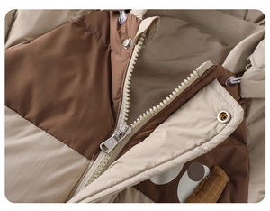Detail view of winter puffer jumpsuit featuring a high collar with metal snap buttons