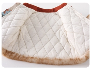 Detail of baby girl New Year outfit showing quilted lining and faux fur trim
