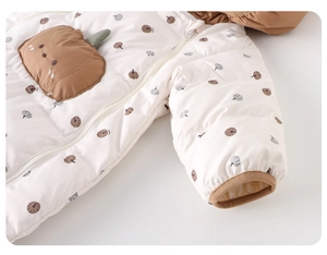 Detailed macro view of the baby winter jumpsuit with cute pumpkin prints and zip