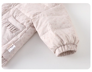 Detail of pink floral baby down jacket showing ruffled pockets and elastic ribbed cuffs